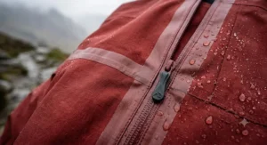 Close-up view of taped seams and waterproof zips on a high-performance hardshell jacket.
