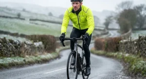 Cyclist wearing the best cycling rain jacket over thermal layers for winter riding