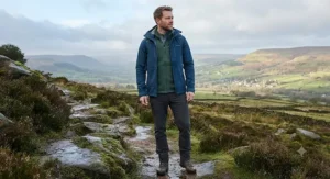 Demonstration of a breathable softshell jacket layered over a fleece for changing UK weather conditions.