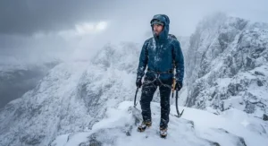 Mountaineer wearing a durable hardshell jacket in snowy conditions in the UK
