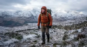Hiker wearing a warm, insulated best walking jacket designed for cold weather and winter hikes across British hills.