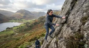 A person wearing a versatile, lightweight softshell jacket while climbing a crag in the Lake District.