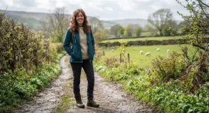 Woman wearing a versatile women's packable rain jacket layered over a jumper for transitional weather