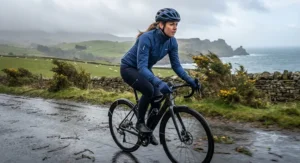 A female rider braving chilly spring gales and showers wearing a windproof and waterproof womens cycling rain jacket.