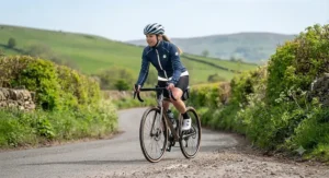 Woman wearing a fitted softshell jacket for cycling with reflective details for safety