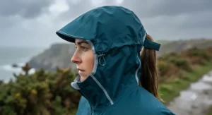 Detailed view of an adjustable hood on a windproof womens running rain jacket designed for stormy British weather