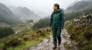 Durable Gore-Tex womens waterproof shell jacket worn during a rainy trek through a national park