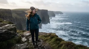 Traveler wearing a breathable insulated waterproof parka on a windy British coastline